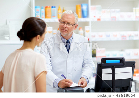senior apothecary with prescription at pharmacy senior apothecary with prescription at pharmacy 43619654