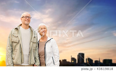 senior couple hugging over evening tallinn city 43619818