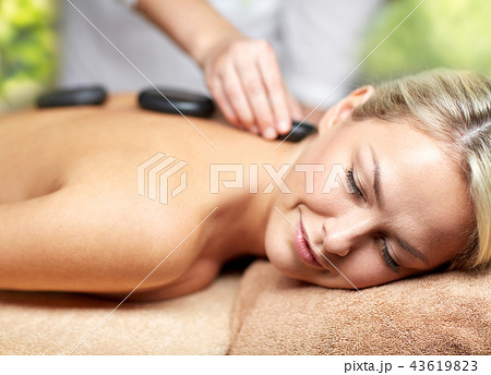 close up of woman having hot stone massage in spa 43619823