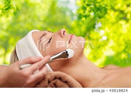 close up of young woman and cosmetologist in spa 43619824