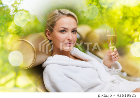 beautiful young woman drinking champagne at spa 43619825