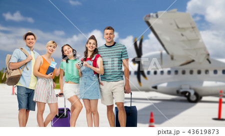 friends with travel bags and camera over airplane friends with travel bags and camera over airplane 43619873