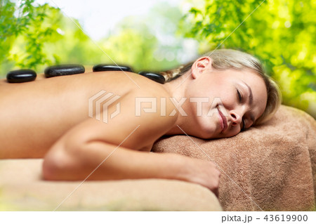 close up of woman having hot stone massage in spa close up of woman having hot stone massage in spa 43619900