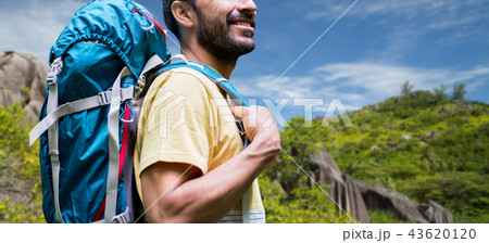 close up of man with backpack over seychelles 43620120