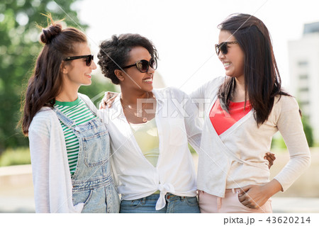 happy young women in sunglasses outdoors 43620214