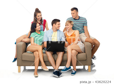 friends with laptop computer sitting on sofa 43620224