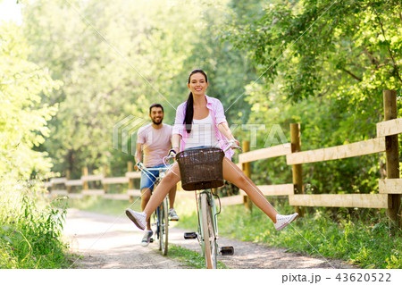 happy couple with bicycles at summer park happy couple with bicycles at summer park 43620522