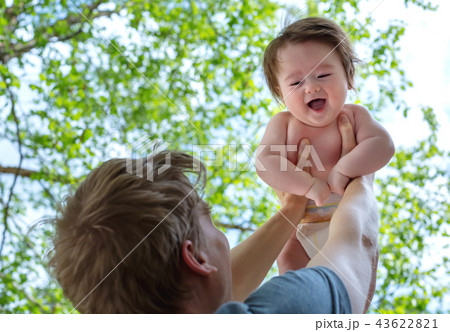 Father holding up his happy baby boy Father holding up his happy baby boy 43622821