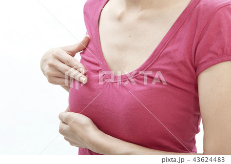 Woman examining herself for breast cancer 43624483