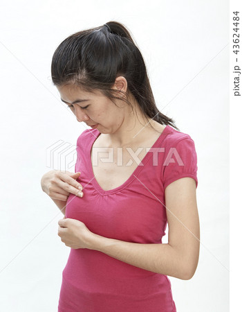 Woman examining herself for breast cancer 43624484