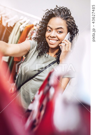 Stylish ethnic woman speaking on phone in shop 43627485