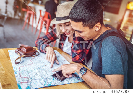 Smiling couple planning route with city map 43628208