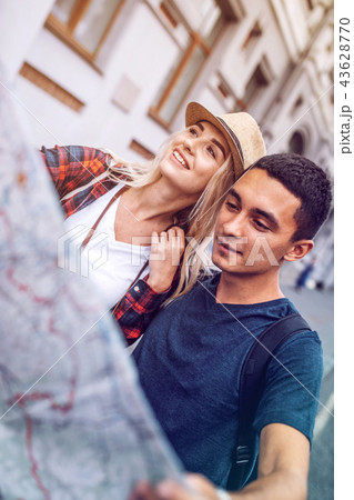 Smiling woman with map exploring city map Smiling woman with map exploring city map 43628770