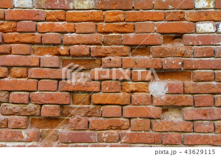 Background of old vintage dirty brick wall with peeling plaster, texture 43629115