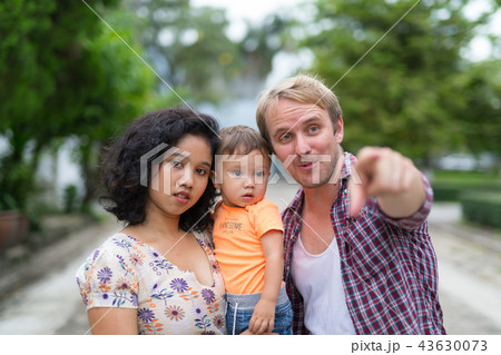 Portrait of happy multi-ethnic family bonding together outdoors Portrait of happy multi-ethnic family bonding together outdoors 43630073