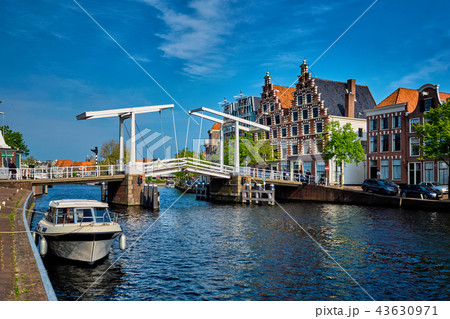Spaarne river with boat and Gravestenenbrug bridge in Haarlem, N Spaarne river with boat and Gravestenenbrug bridge in Haarlem, N 43630971