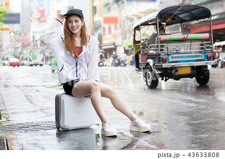 Asian women tourist traveler in sitting on luggage 43633808