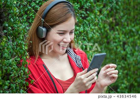 Asian women smiling with headphones 43634546