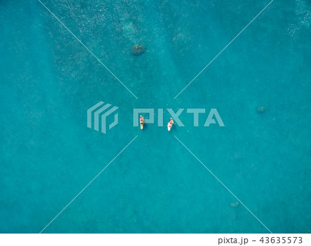 Surfers in tropical ocean waiting wave Surfers in tropical ocean waiting wave 43635573