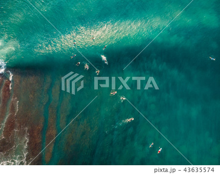 Aerial view with surfers and wave in blue ocean 43635574