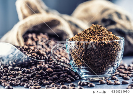 Granules of instant coffee in glass cupfrom beans. Granules of instant coffee in glass cupfrom beans. 43635940