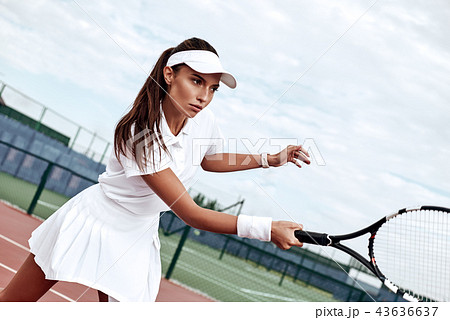 Tennis player playing on the court on a sunny day Tennis player playing on the court on a sunny day 43636637