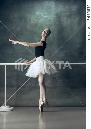 The classic ballerina posing at ballet barre 43636650