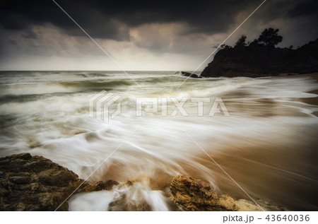 Beautiful white wave flow hitting the sandy beach 43640036