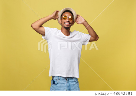 Close up portrait of young afro american shocked tourist , holding his eyewear, wearing tourist 43642591