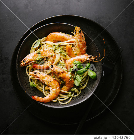 Spaghetti with pesto and prawns served on plate 43642766