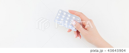 Female hand with pills in blister Female hand with pills in blister 43643904