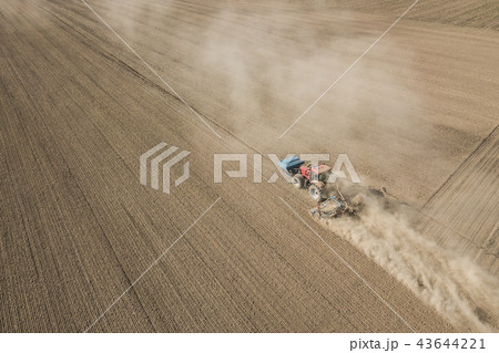 Tractor plowing field 43644221