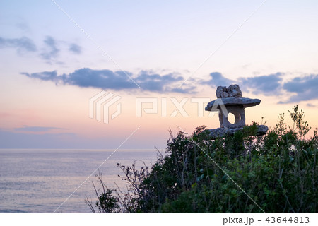 Silhouette of an old stone lantern at sunset Silhouette of an old stone lantern at sunset 43644813