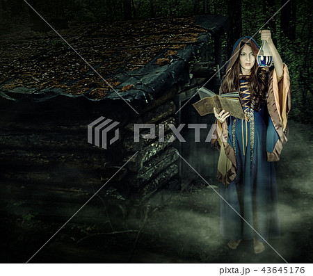 Beautiful young halloween witch girl casting magic Beautiful young halloween witch girl casting magic 43645176
