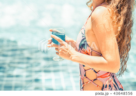 Happy young woman in swimsuit at swimming pool. Happy young woman in swimsuit at swimming pool. 43648556