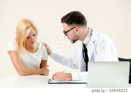 Male Doctor and Female Patient in Hospital Office 43648822