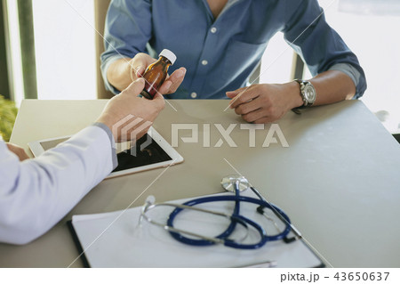 The doctor is explaining something the medicine  The doctor is explaining something the medicine  43650637