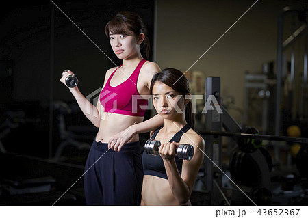 スポーツジム 女性 ダンベル 筋トレの写真素材