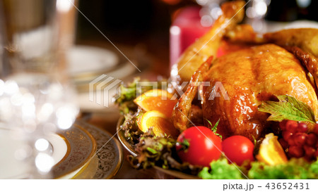 Closeup image of baked chicken with vegetables on served dinner table Closeup image of baked chicken with vegetables on served dinner table 43652431