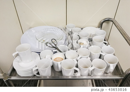 Pile of dirty used cups and plates for cleaning 43653016
