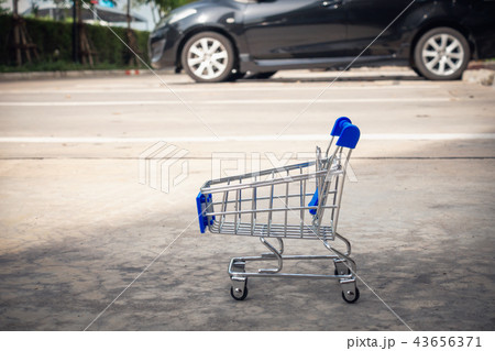 Mini shopping cart in car parking lot, Shopping Mini shopping cart in car parking lot, Shopping 43656371