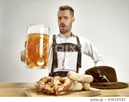 Germany, Bavaria, Upper Bavaria, man with beer dressed in traditional Austrian or Bavarian costume Germany, Bavaria, Upper Bavaria, man with beer dressed in traditional Austrian or Bavarian costume 43659585