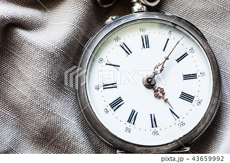 vintage pocket watch on gray textile background vintage pocket watch on gray textile background 43659992
