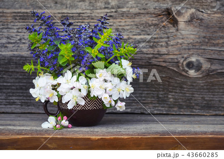 Bouquet of spring flowers on wooden background Bouquet of spring flowers on wooden background 43660285