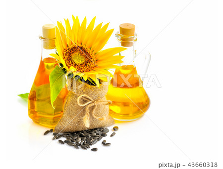 Sunflower and seeds in small bag and bottle of oil Sunflower and seeds in small bag and bottle of oil 43660318