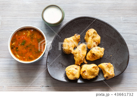 Chicken Pakoda pieces on plate on wooden table 43661732