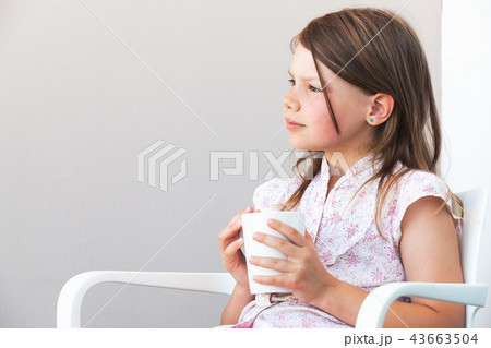 Portrait of blond little girl with white cup 43663504