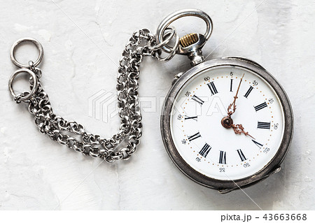 retro pocket watch with chain on white plaster 43663668
