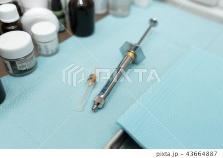 dental syringe for anesthesia lies on the table with other drugs dental syringe for anesthesia lies on the table with other drugs 43664887
