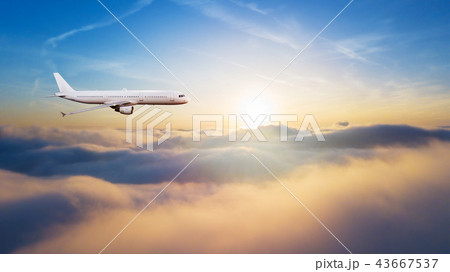 Detail of commercial airplane flying above clouds Detail of commercial airplane flying above clouds 43667537